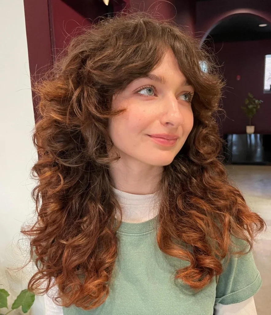 15 Wolf Cut Curly Hair Looks You’ll Love 13 Curly Wolf Cut with Curtain Bangs