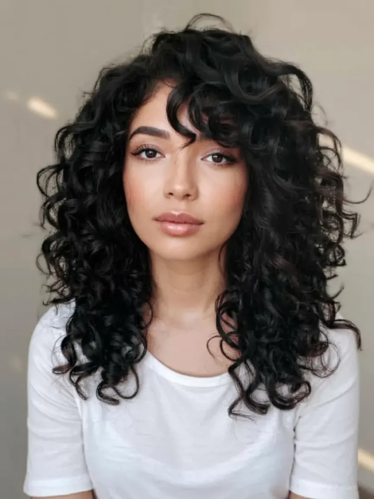 15 Wolf Cut Curly Hair Looks You’ll Love 9 9. Voluminous Curly Wolf Cut